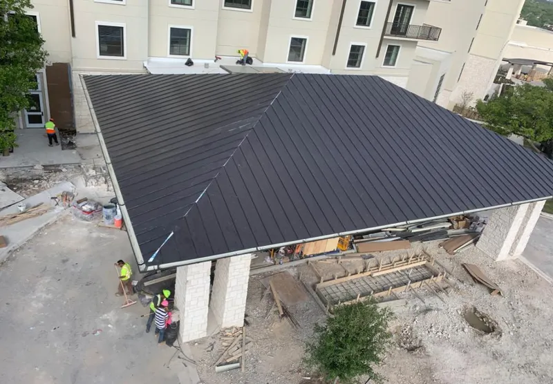 Metal roofing installation team working on a commercial building in McComb